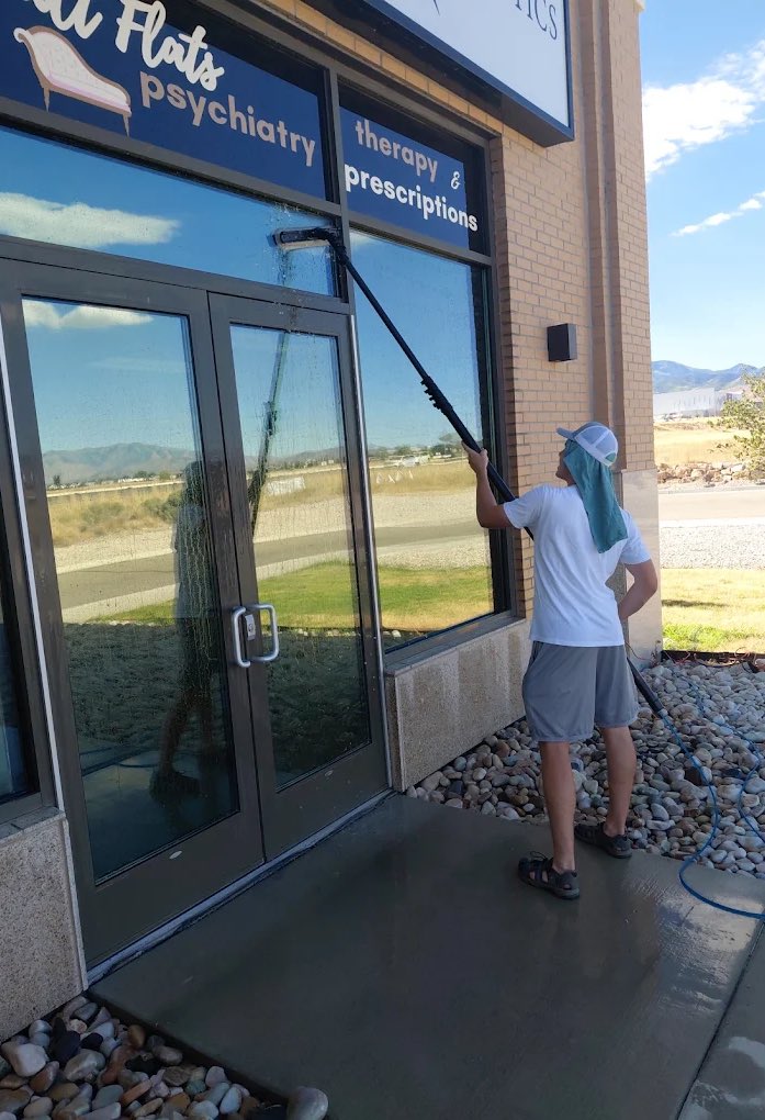 Cleaning the front windows of an office building